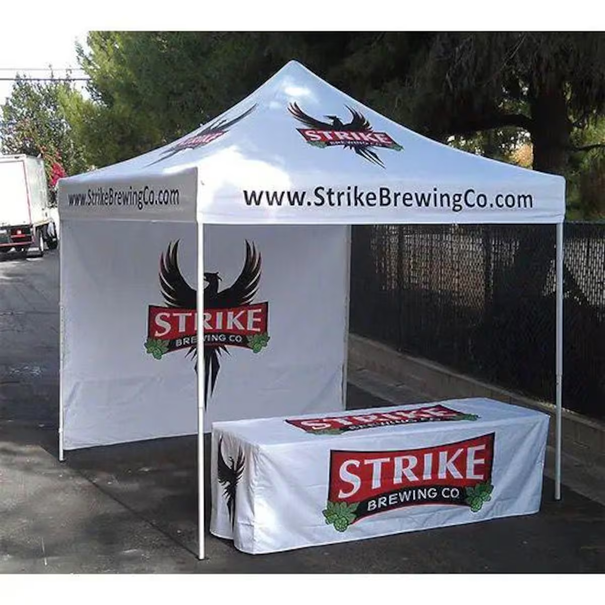 White custom canopy tent with printed logo, sidewall and matching table cover for Strike Brewing Co.